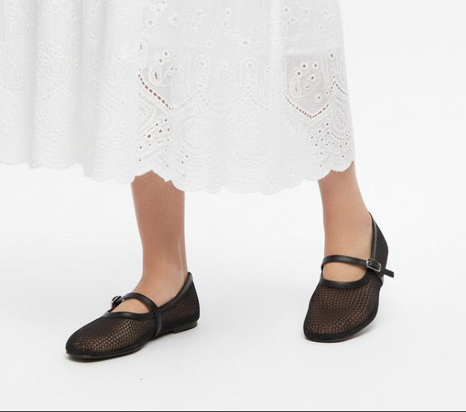 woman wearing black fishnet pumps